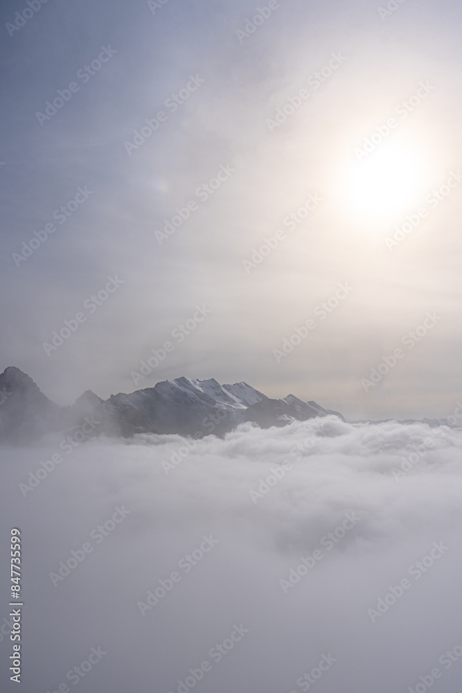 View of Swiss Alps over clouds on a bright sunny day from Schilthorn summit in Switzerland