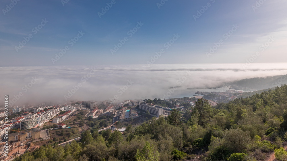 Panorama showing aerial View of Sesimbra Town and Port covered by fog timelapse, Portugal. Panorama showing aerial View of Sesimbra Town and Port covered by fog timelapse, Portugal.