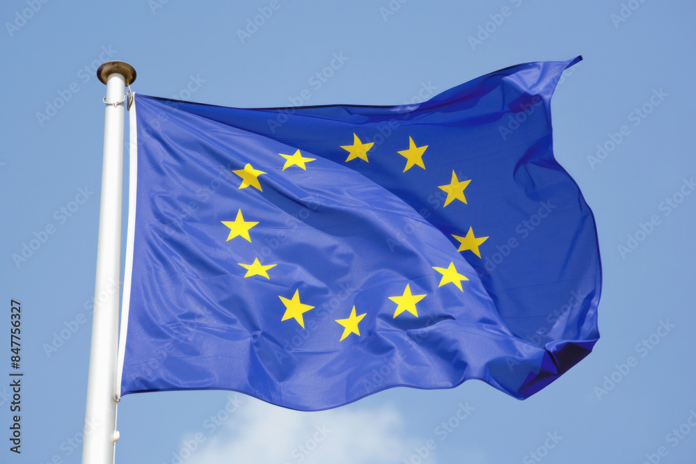 The flag is electric blue with yellow stars, representing the sky and water, waving at the event The flag is electric blue with yellow stars, representing the sky and water, waving at the event