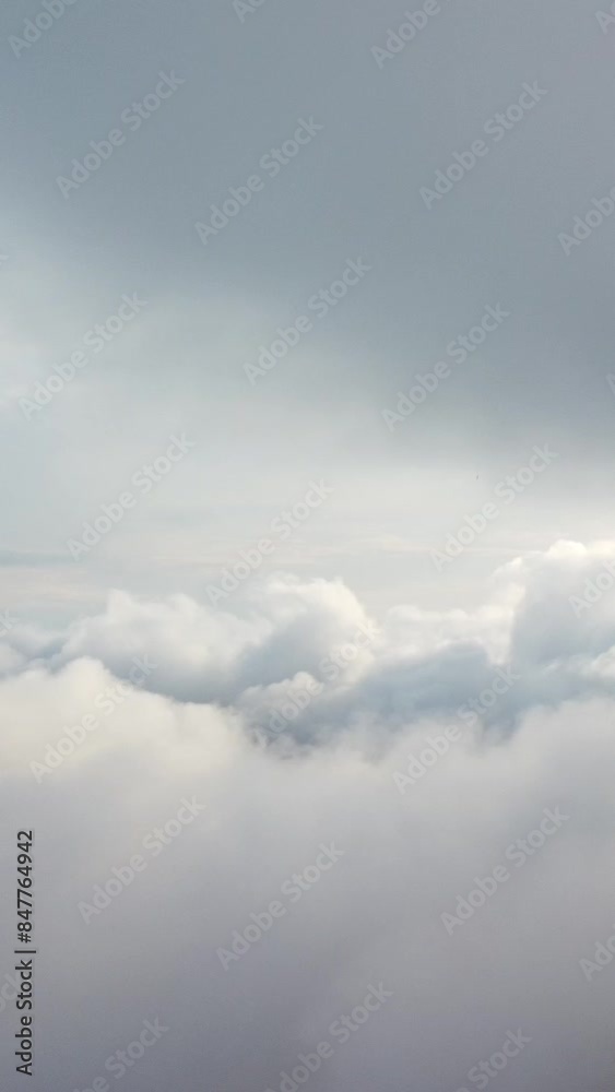 Aerial vertical view over foggy and fluffy clouds. Blue sky sun, sea fog. Abstract nature summer ocean sunset sea and sky background. Vacation, travel and holiday concept. Weather and climate change Aerial vertical view over foggy and fluffy clouds. Blue sky sun, sea fog. Abstract nature summer ocean sunset sea and sky background. Vacation, travel and holiday concept. Weather and climate change