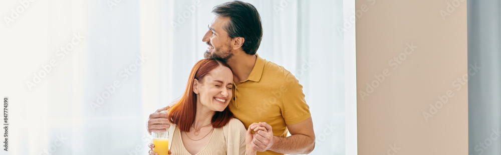 Redhead woman and bearded man share a heartfelt hug, basking in the warmth of their love in a modern apartment. Redhead woman and bearded man share a heartfelt hug, basking in the warmth of their love in a modern apartment.