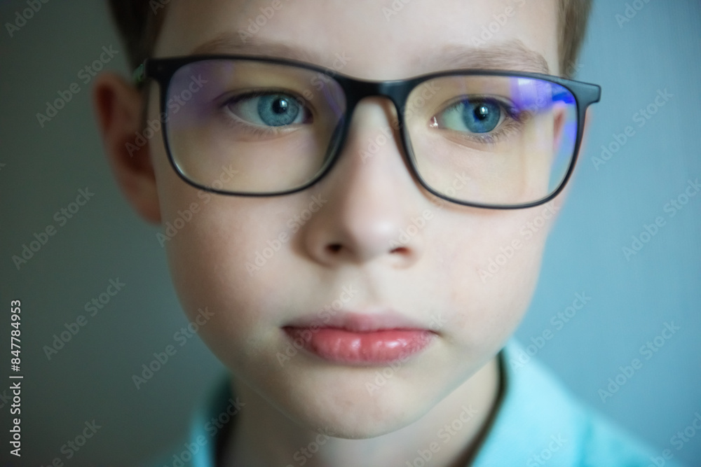 close up part child face, boy 10 years old wearing glasses, human eye looking to side, vision examination, diagnosis, treatment ophthalmic diseases, emotional development children