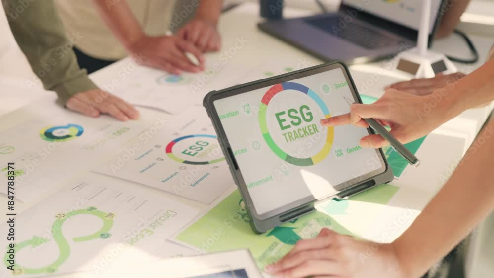 Analyzing ESG Metrics and Sustainability Performance on Tablet. Analyzing ESG Metrics and Sustainability Performance on Tablet.