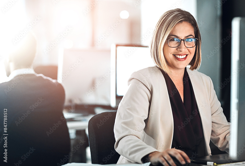 Portrait, smile and businesswoman with glasses for work, computer and positive response in office. Happy person, corporate industry and report at desk for review, communication and research online Portrait, smile and businesswoman with glasses for work, computer and positive response in office. Happy person, corporate industry and report at desk for review, communication and research online
