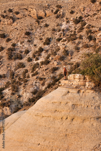 hiker standing on the top of a rock in dana biosphere reserve