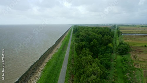 Aerial: Sea dyke view along the road, small jungle, North Atlantic Ocean and Nickerie Suriname photo