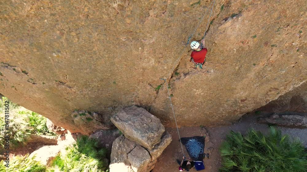 Man rock climbing aerial view of sportsman rapelling mountain in La Panocha, el Valle Murcia, Spain woman rapel down a mountain climbing a big rock Man rock climbing aerial view of sportsman rapelling mountain in La Panocha, el Valle Murcia, Spain woman rapel down a mountain climbing a big rock