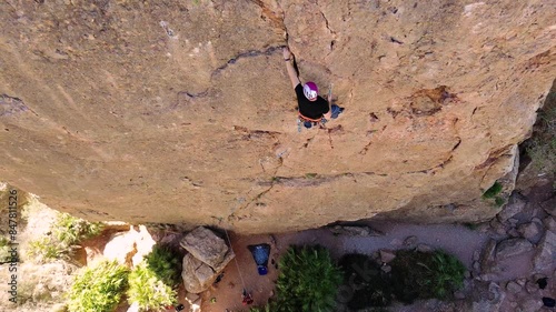 Man rock climbing aerial view of sportsman rapelling mountain in La Panocha, el Valle Murcia, Spain woman rapel down a mountain climbing a big rock photo