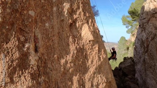 Man rock climbing aerial view of sportsman rapelling mountain in La Panocha, el Valle Murcia, Spain woman rapel down a mountain climbing a big rock photo