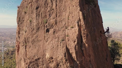 Man rock climbing aerial view of sportsman rapelling mountain in La Panocha, el Valle Murcia, Spain woman rapel down a mountain climbing a big rock photo