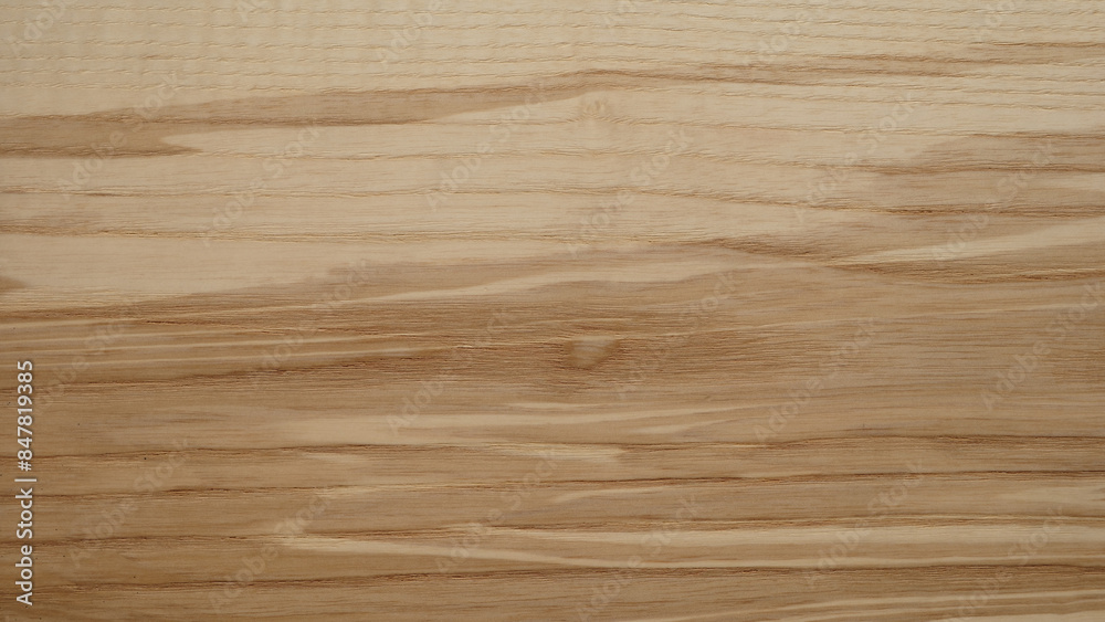 A wooden surface with a grainy texture background. The wood appears to be aged and has a natural, rustic feel to it. The grain of the wood is visible in the image A wooden surface with a grainy texture background. The wood appears to be aged and has a natural, rustic feel to it. The grain of the wood is visible in the image