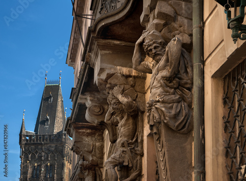 Muscular atlas support an old balcony and white window, Nerudova Street, Prague
