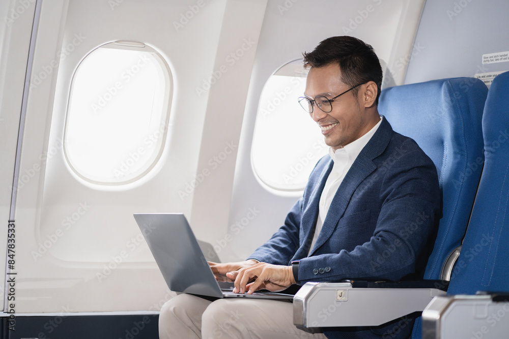 Successful business man, Airplane, travel, enjoying comfortable flight while sitting in the airplane cabin. Successful business man, Airplane, travel, enjoying comfortable flight while sitting in the airplane cabin.