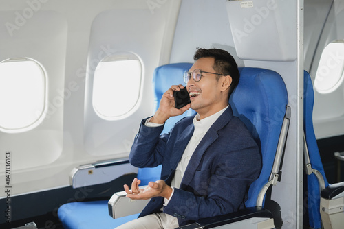 Successful business man, Airplane, travel, enjoying comfortable flight while sitting in the airplane cabin.