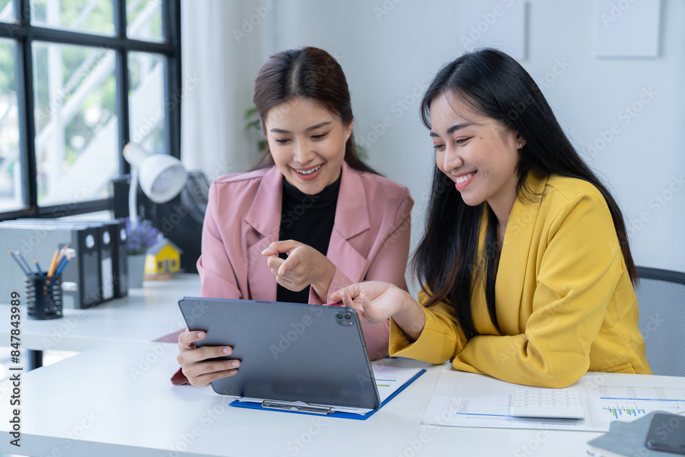 two women are while working on laptop and and consult for new project two women are while working on laptop and and consult for new project