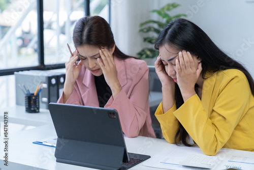 two women are while working on laptop and and consult for new project