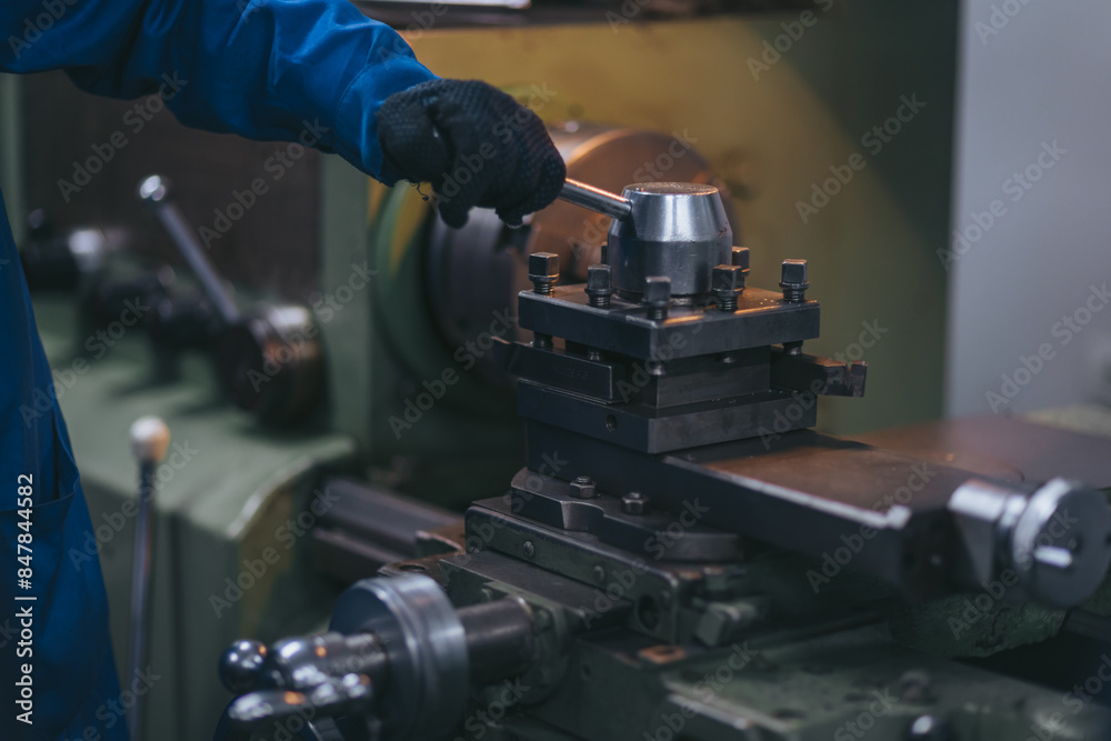 Metallurgy industry. Factory for production of heavy pellet stoves and boilers. Manual worker preparing parts for production. Selective focus. Metallurgy industry. Factory for production of heavy pellet stoves and boilers. Manual worker preparing parts for production. Selective focus.