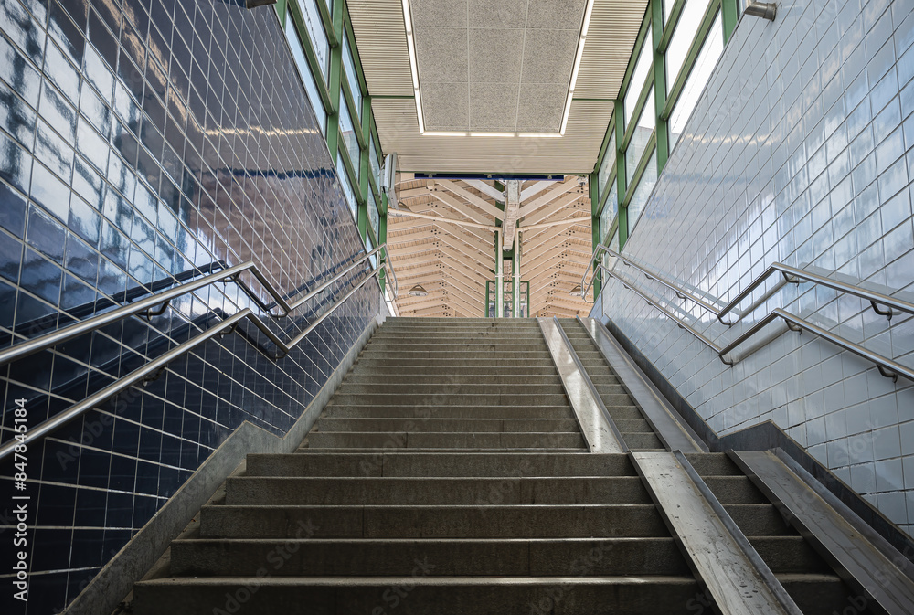Obraz premium pedestrian stairs from the underpass to the train station, urban life