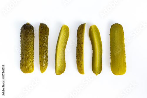 variation cucumber dill pickle cut into spears, isolated on white background, flat lay