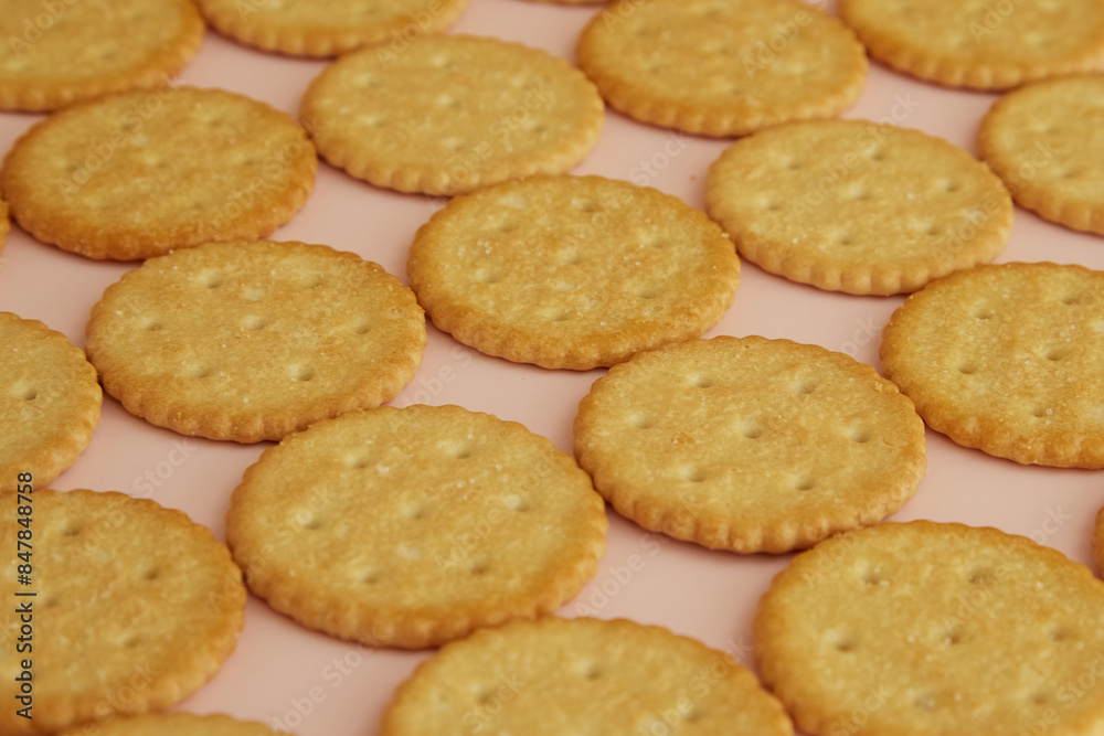 Salty crackers on a pink background close-up, cookies on a pink background, cookies on the table Salty crackers on a pink background close-up, cookies on a pink background, cookies on the table