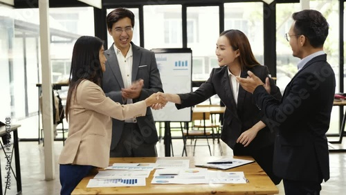 Businessmen shaking hands for teamwork of business mergers and acquisitions, successful negotiations at a meeting, shaking hands, greeting before brainstorming meeting in company sitting at table.