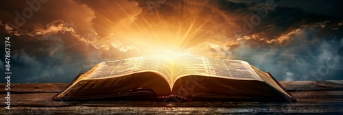 An open Bible with rays of golden light emanating from it