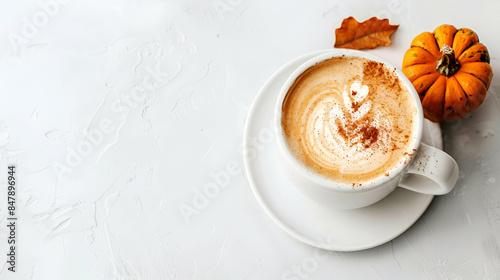 Cozy autumn vibe with pumpkin spice latte and fallen leaves, copy space photo