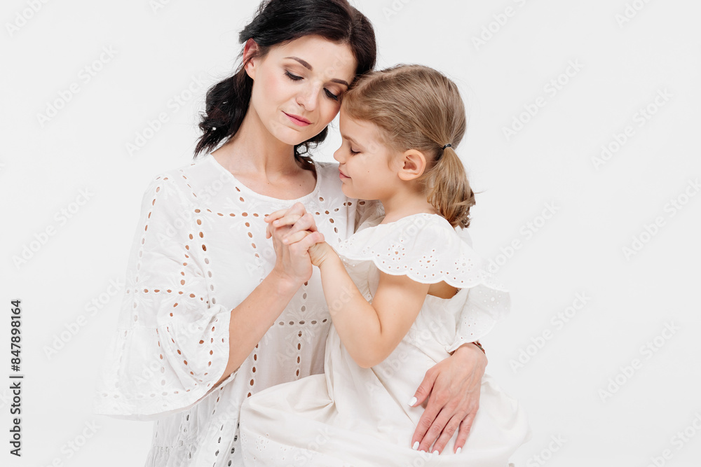 Close-up of tender touches and sensitive moment between mother and daughter. Close-up of tender touches and sensitive moment between mother and daughter.