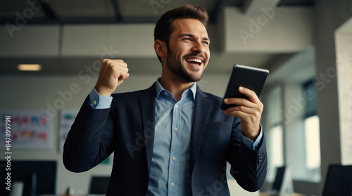 A businessman in a business suit rejoices at a successful deal with investors, the emotion of delight on his face, financial literacy, large and small businesses, new technologies.
