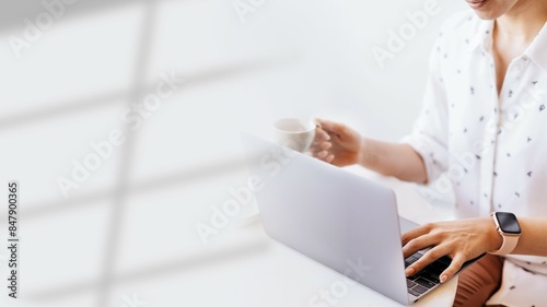 Businesswoman drinking coffee while working at home