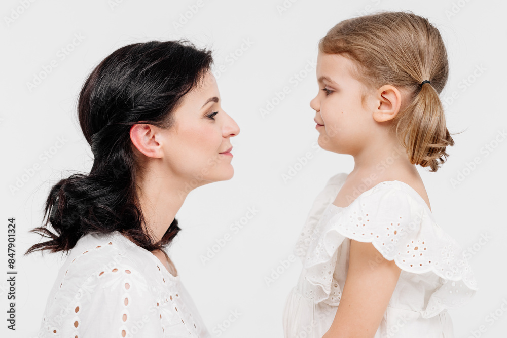 Close-up of tender touches and sensitive moment between mother and daughter. Close-up of tender touches and sensitive moment between mother and daughter.