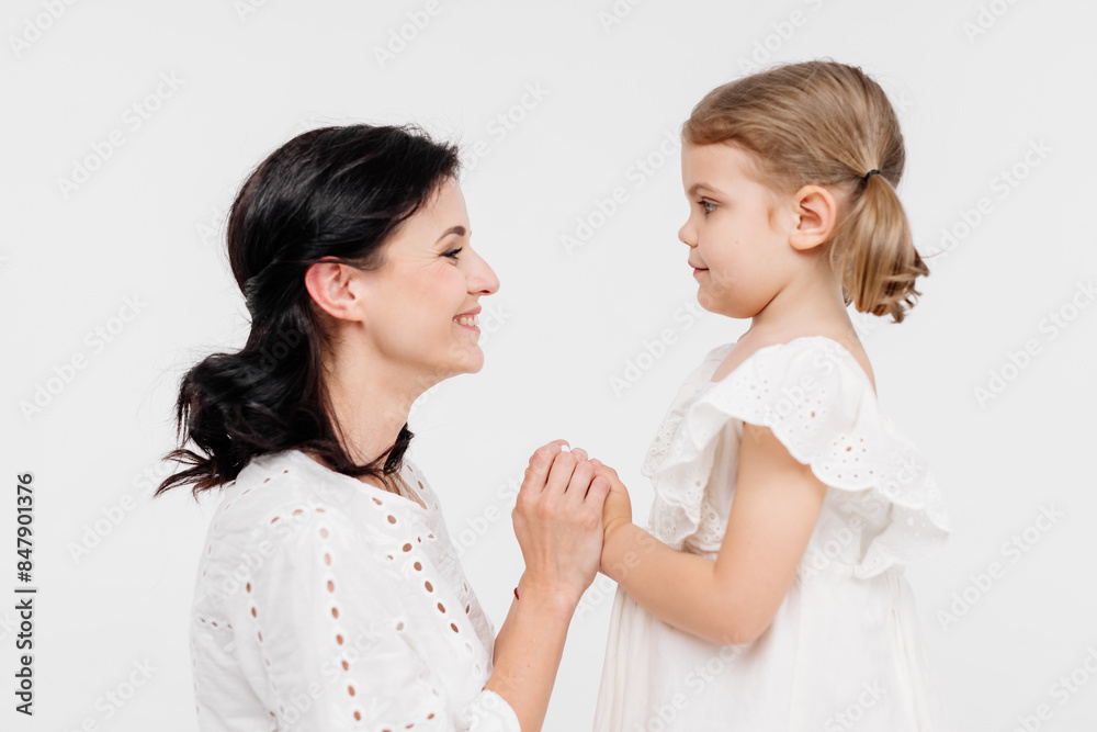 Close-up of tender touches and sensitive moment between mother and daughter. Close-up of tender touches and sensitive moment between mother and daughter.