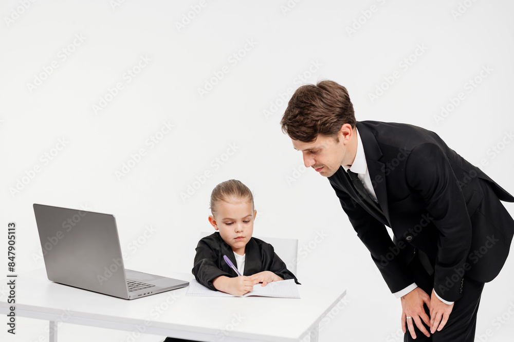 Close-up of a stylish business girl child studying at a laptop on an isolated white background. The concept of modern technology, business and education. Close-up of a stylish business girl child studying at a laptop on an isolated white background. The concept of modern technology, business and education.