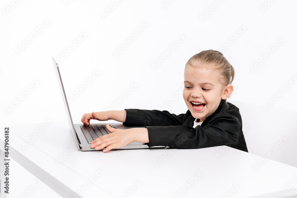 Small, busy businesswoman working at a laptop on a light isolated studio background. Concept of deal, business and modern technology. Small, busy businesswoman working at a laptop on a light isolated studio background. Concept of deal, business and modern technology.