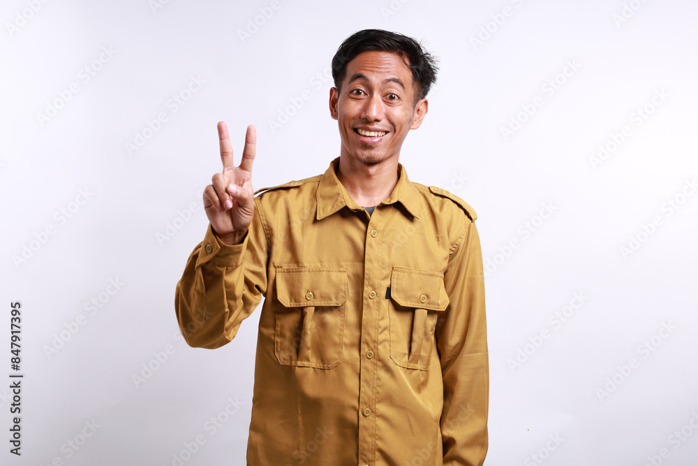 Enthusiastic Indonesian government employees standing while showing two fingers. Isolated on white Enthusiastic Indonesian government employees standing while showing two fingers. Isolated on white