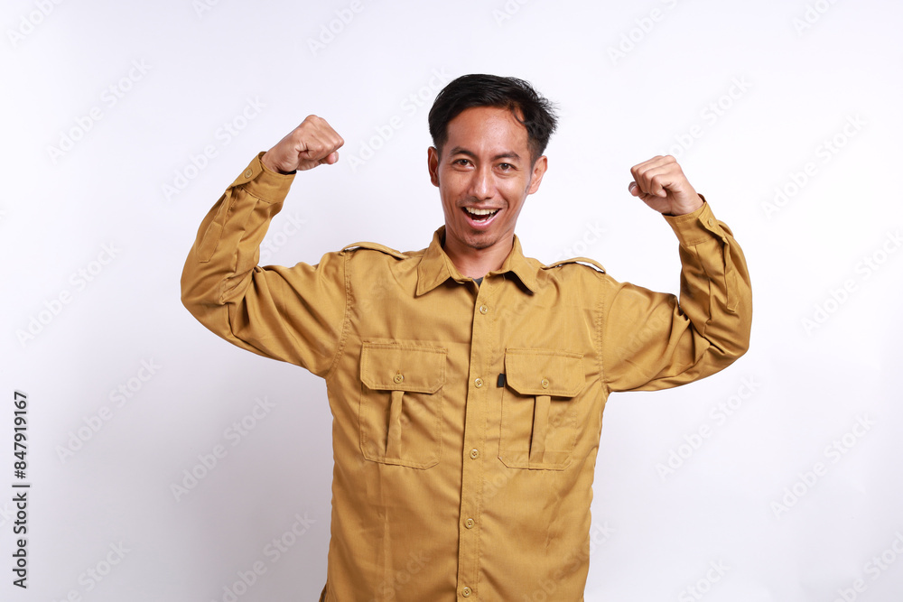 Happy Indonesian government employees standing while showing strong gesture. Isolated on white background Happy Indonesian government employees standing while showing strong gesture. Isolated on white background
