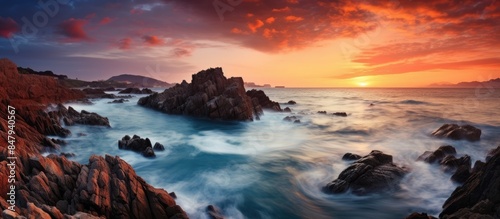perfect sunset with sharp rocky seashore amazing seascape. Creative banner. Copyspace image