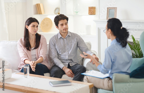 Slika na platnu In the therapist's office, a young couple opens up about their relationship, facilitated by a compassionate female counselor aiming to strengthen their bond