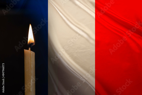 mourning candle burning front of flag France, Victims of cataclysm or war concept, memory of heroes served country, grief over loss, national unity in challenging times, state's history