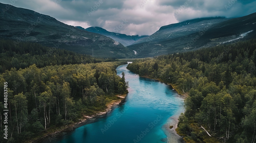 A scenic aerial view of the mountain landscape in Jotunheimen National Park showcases the rugged beauty of Norway's wilderness. The park is renowned for its dramatic peaks, deep valleys, and pristinE