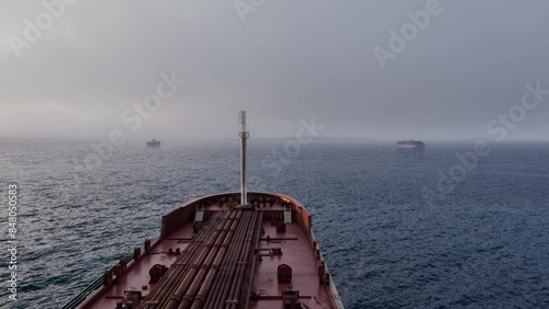 Misty Sea Journey Ships visible in the foggy horizon with foreboding skies above photo