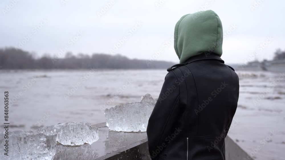 A girl watches an ice drift on the embankment on the Belaya River in Ufa. A girl watches an ice drift on the embankment on the Belaya River in Ufa.
