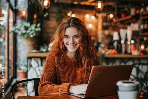Woman Working on Laptop in Cozy Cafe