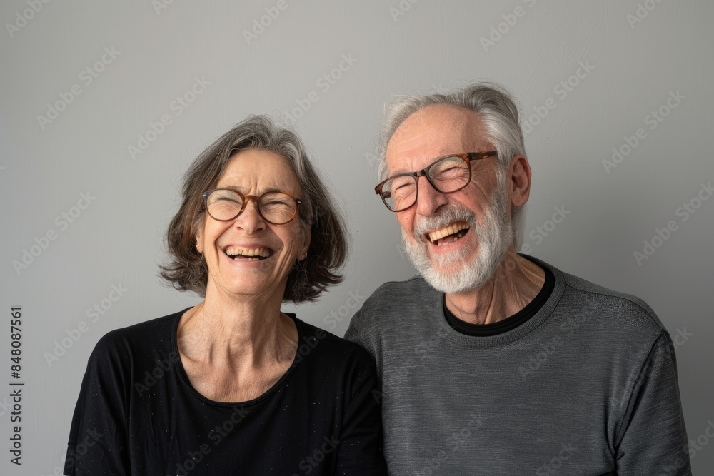 Portrait of a joyful couple in their 50s wearing a simple cotton shirt isolated in plain cyclorama studio wall Portrait of a joyful couple in their 50s wearing a simple cotton shirt isolated in plain cyclorama studio wall