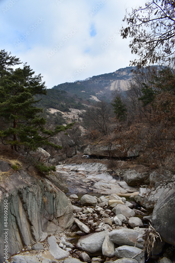 Rocky frozen river bed running along a walking trail in Bukhansan National Park