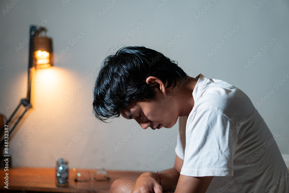 Obraz premium Person in deep thought with a lit lamp in the background