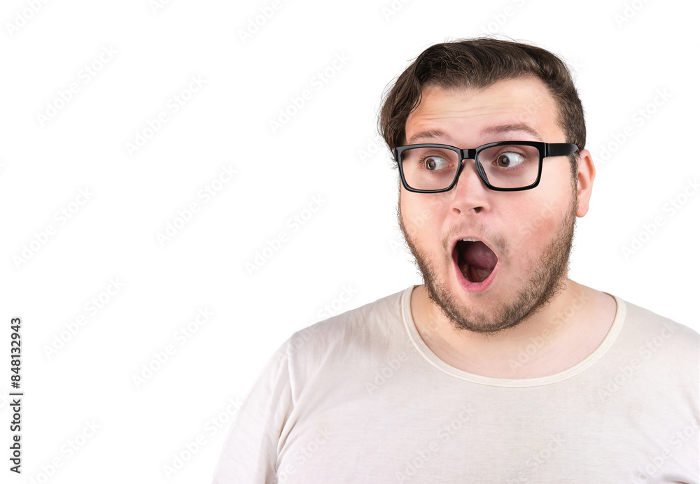 Surprised stunned young man in glasses looking to the side Surprised stunned young man in glasses looking to the side