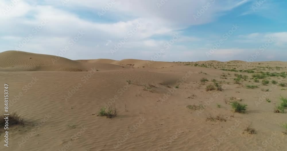 Drone flies over the sand dunes of the desert on a cloudy day Drone flies over the sand dunes of the desert on a cloudy day