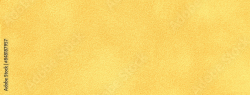 Light yellow matte background of suede fabric, closeup. Velvet texture of golden textile, macro.