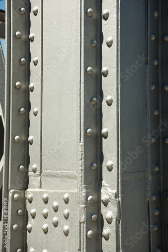 Close-up detail shot of vintage steel girder structure supporting a tower. 